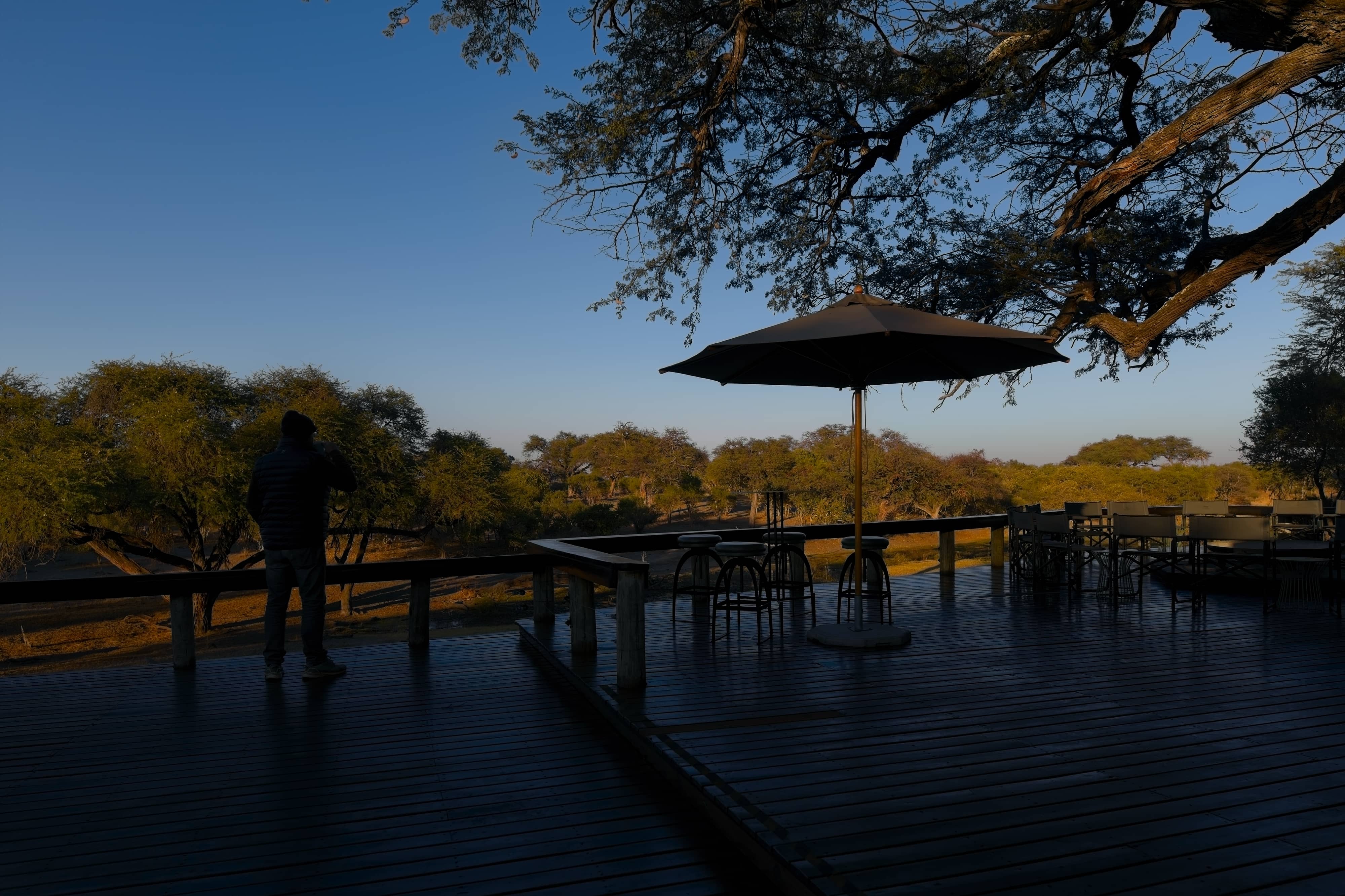 Image of a guest looking at the sunrise at a safari lodge in Botswana