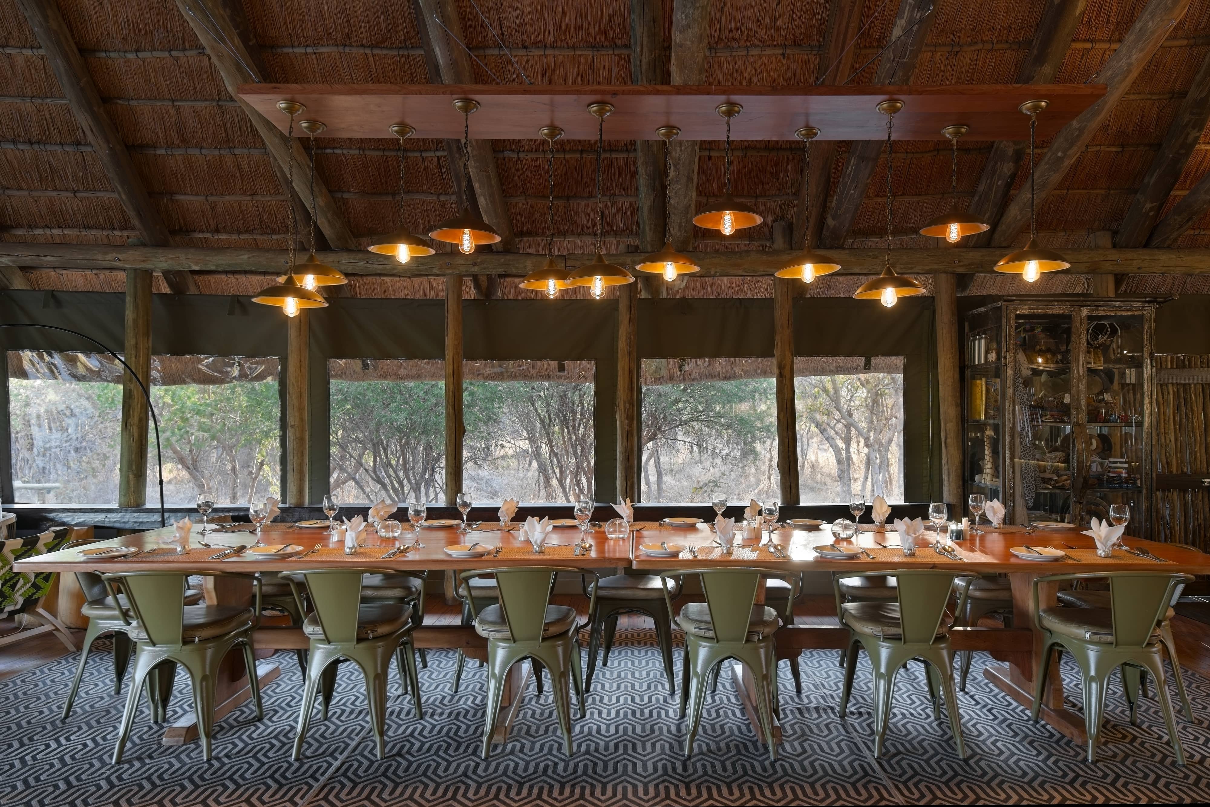 Mogotlho Safari Lodge dining table set for dinner guests