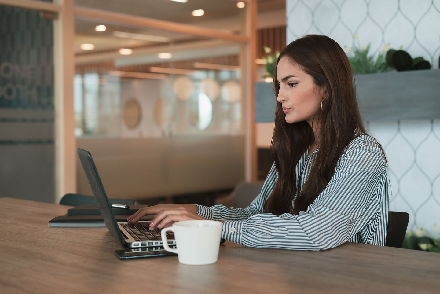 Canadian entrepreneur filing small business taxes for the first time on a laptop in a modern office