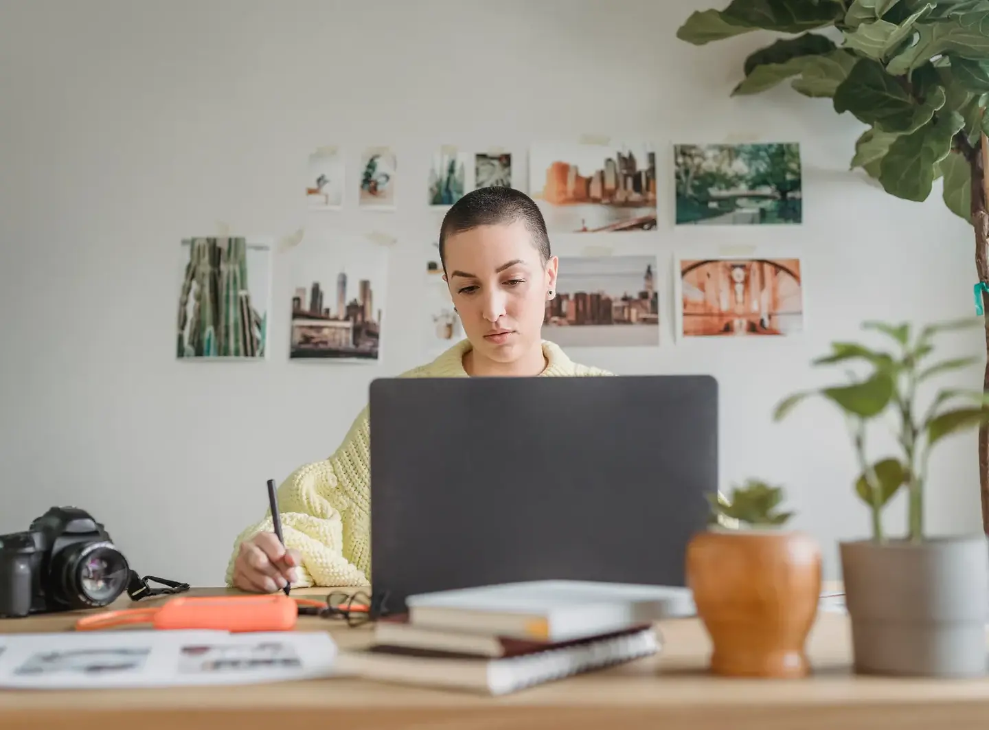 Freelance designer working on a laptop in a bright studio as an independent contractor