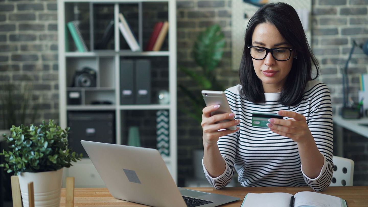Person tracking spending on a budgeting app after Mint shut down