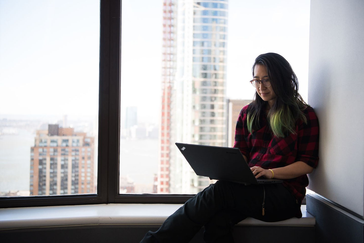Business owner planning at a laptop, weighing whether to stay a solopreneur or grow into an entrepreneur