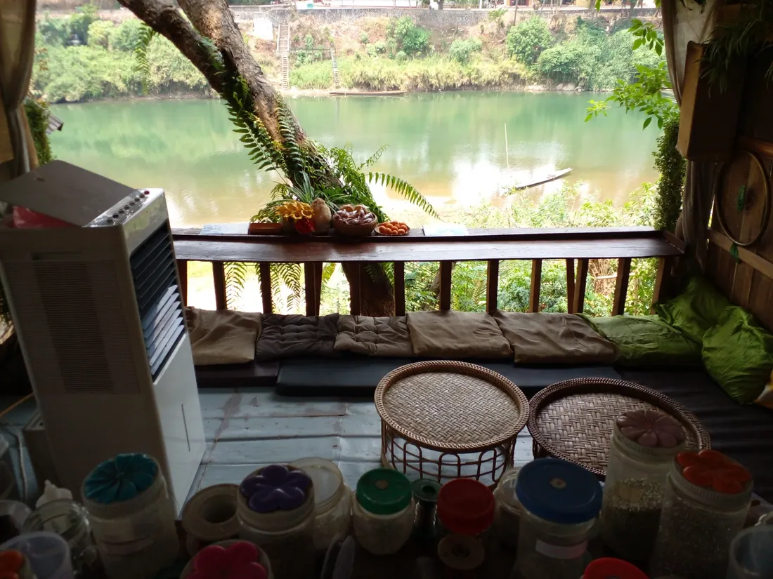 Jars of materials in the foreground, stunning lake in the background and a lovely balcony in the middle