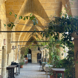 Sandstone archway with green vines around
