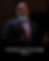 Man in a dark suit and pink tie speaks expressively, dark background. Text below reads "Voddie Baucham Jr. 1969-2025."