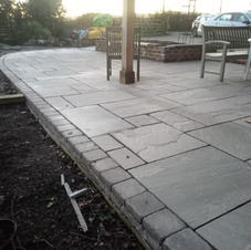 large natural stone patio nearing completion.jpg