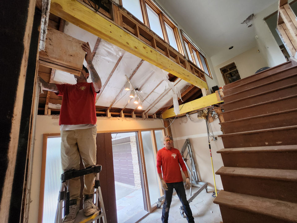 LVL Beam installed to create an open concept entryway by safely supporting the load above and maximizing ceiling height in a residential home in Hamilton, Ontario