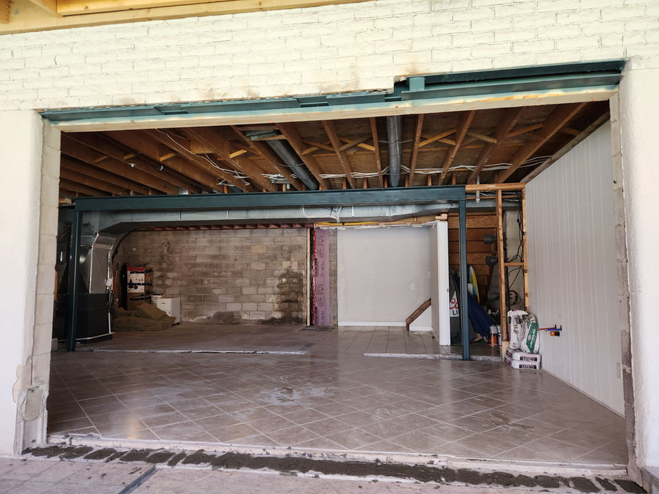 steel beam installed in basement supporting floor above with future patio door cut out in foreground, Burlington, Oakville, Hamilton, Golden Horseshoe, Ontario
