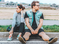 Two people looking in opposite directions during a disagreement about being right, listening, and seeing another perspective.