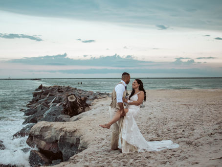 Destination wedding couple at dramatic cliffside beach.