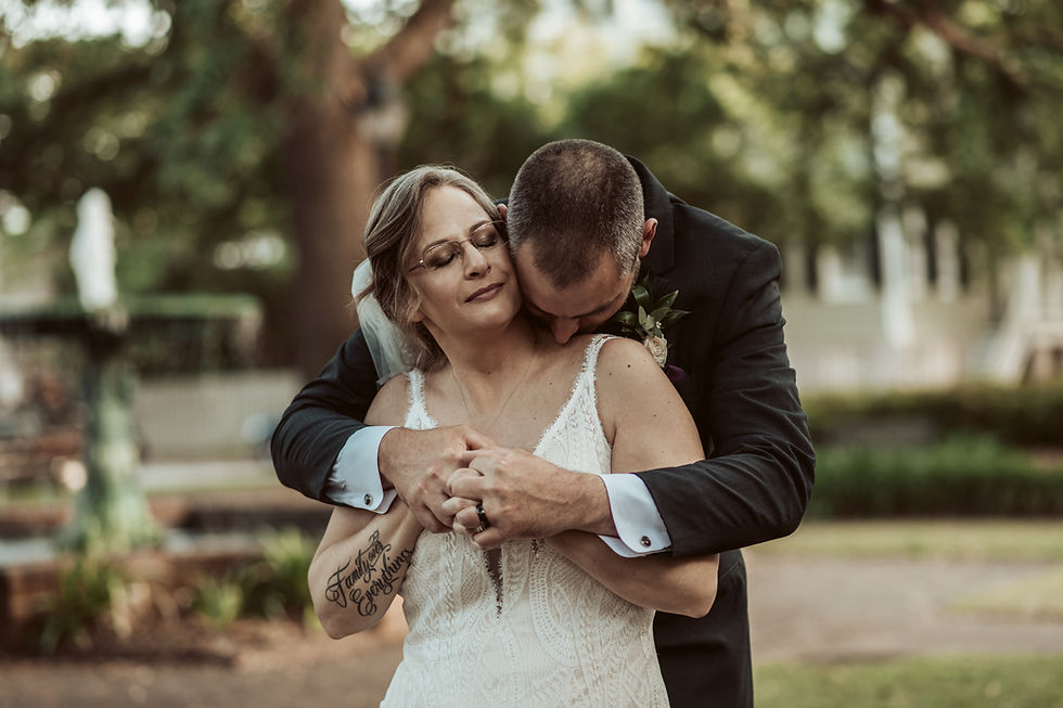 Romantic shot of bride and groom in front of fountain in Savannah, GA