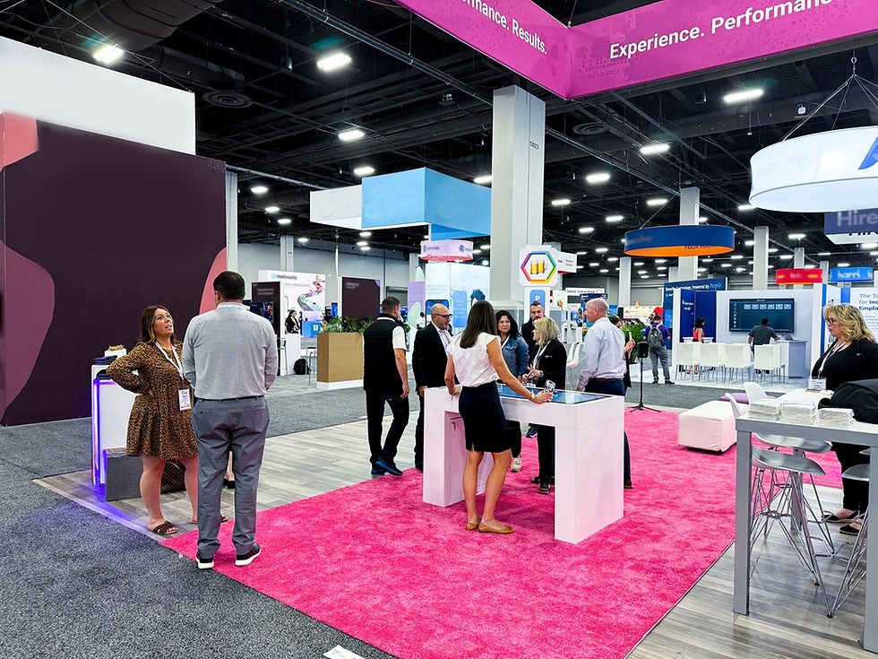 Modern Skyline trade show booth with branded displays and visitors engaging in an interactive exhibit space