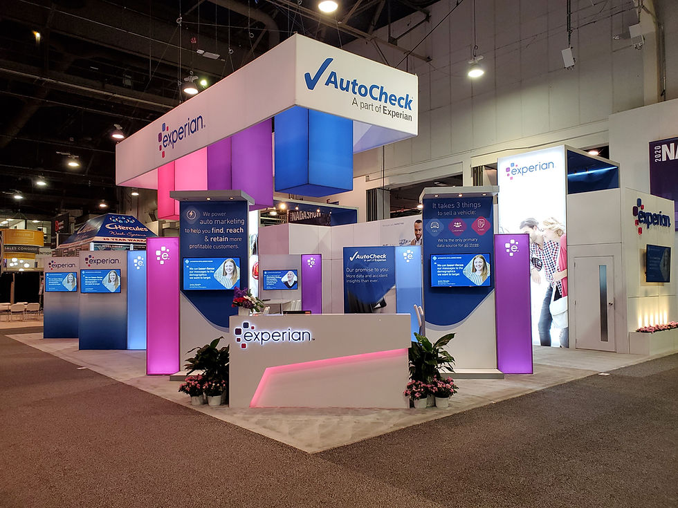 Experian and AutoCheck trade show booth with illuminated signage, digital displays, and modern counters in a large convention hall