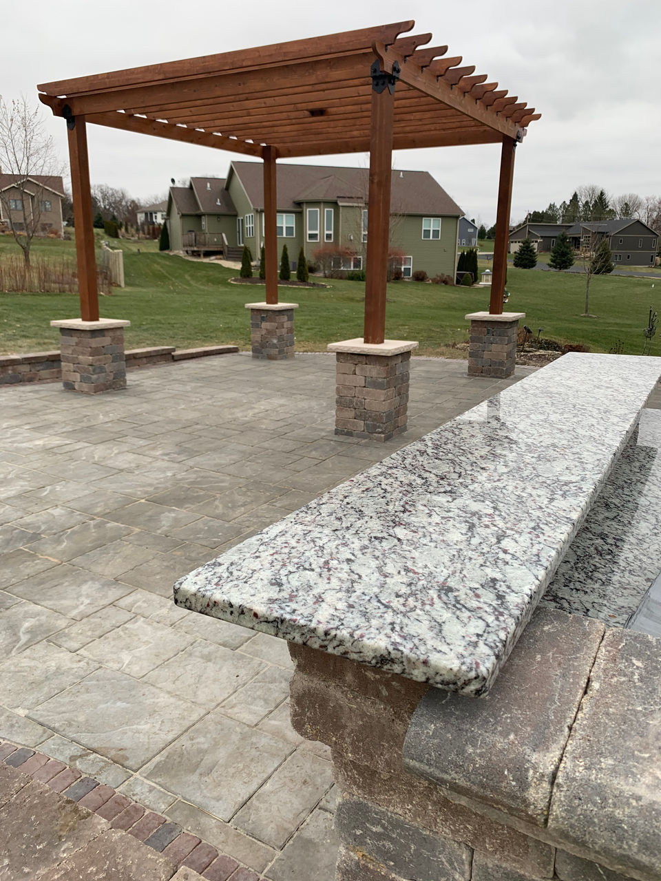 Spacious wooden pergola overlooking manicured lawn - Marvin's Brick Pavers, Madison, WI