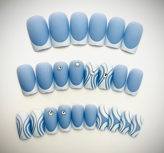 The Stevie set features a Carolina blue base with white French Tips, wavy line designs and rhinestones