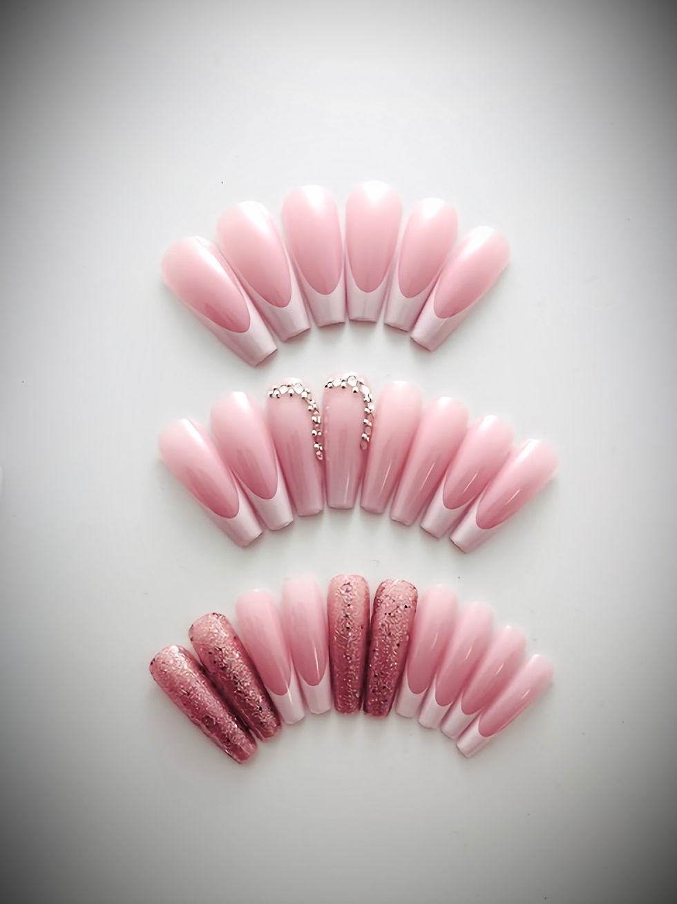 The Emily set features a soft pink base with a classic white French tips, pink glitter and rhinestones