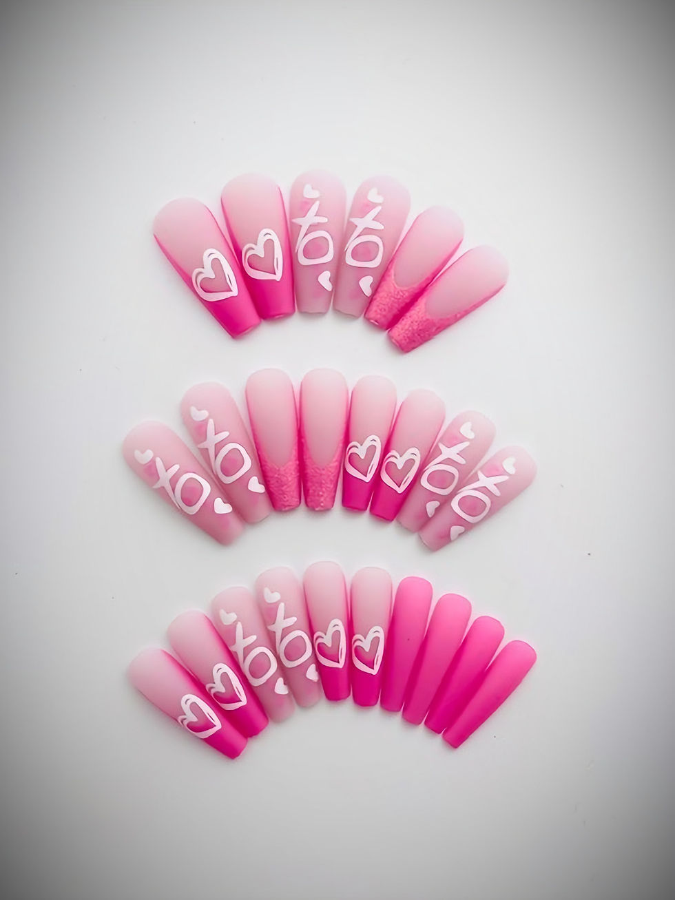 The Roxie set features a soft pink matte base adorned with accents of white "XO" print and dainty pink hearts