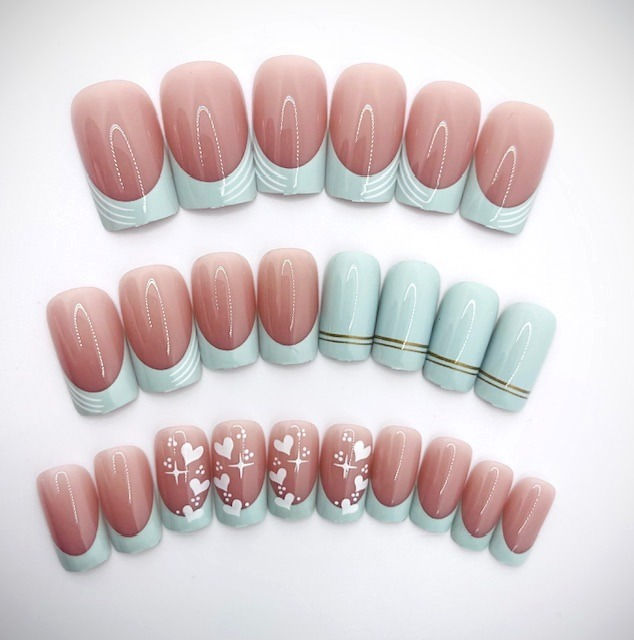 The Elsie set features a tan nude base with mint green french tips, hearts and line designs