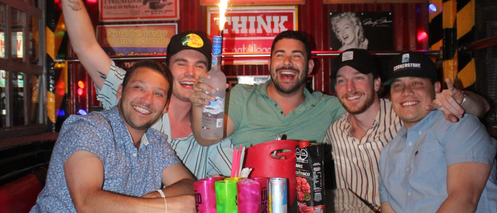 Friends celebrating with sparklers at a bar