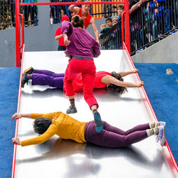 Shira Yaziv running up a slide over Melissa Lewis Wong and Megan Lowe in SF Chinatown.
