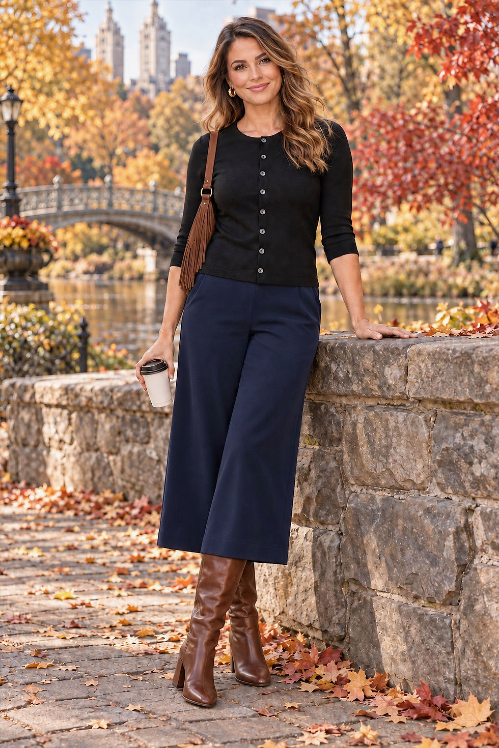 Model wearing Sophie merino wool, round neck button down cardigan in black in relaxed outdoor fall pose.