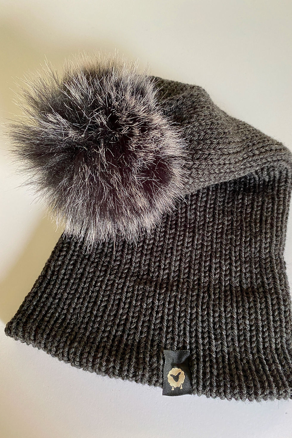 Thumbnail: Close-up of the Pom Beanie in charcoal with black ice pom showing knit texture and pom detail.