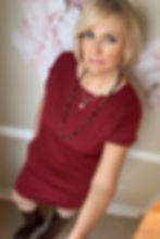 Model wearing the Simone shift dress in Carmine red merino jersey, full-body lifestyle pose.