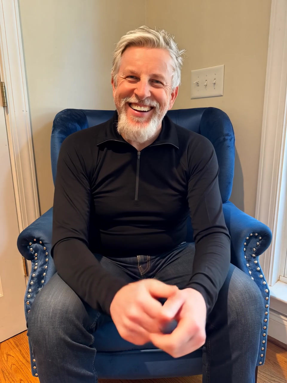 Thumbnail: Video of man wearing the black Riley zip-neck top, showing the movement and drape of the mid-weight merino jersey fabric.