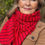 Thumbnail: Close-up of the Merino Travel Wrap and Scarf in lava red stripe showing mid-weight rib merino fabric and texture.
