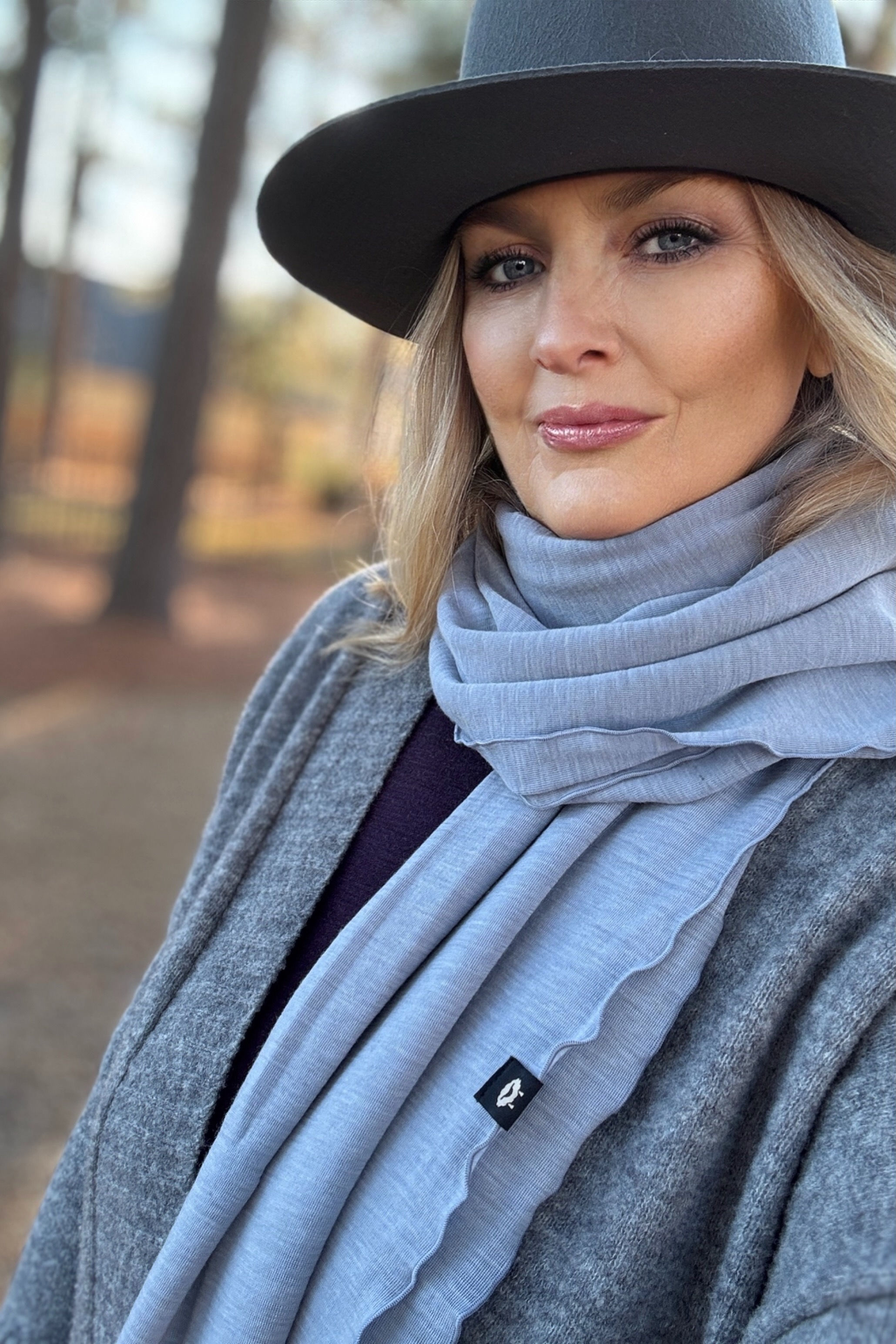 Close-up of the Merino Travel Wrap and Scarf in Armani grey showing mid-weight rib merino fabric and texture.