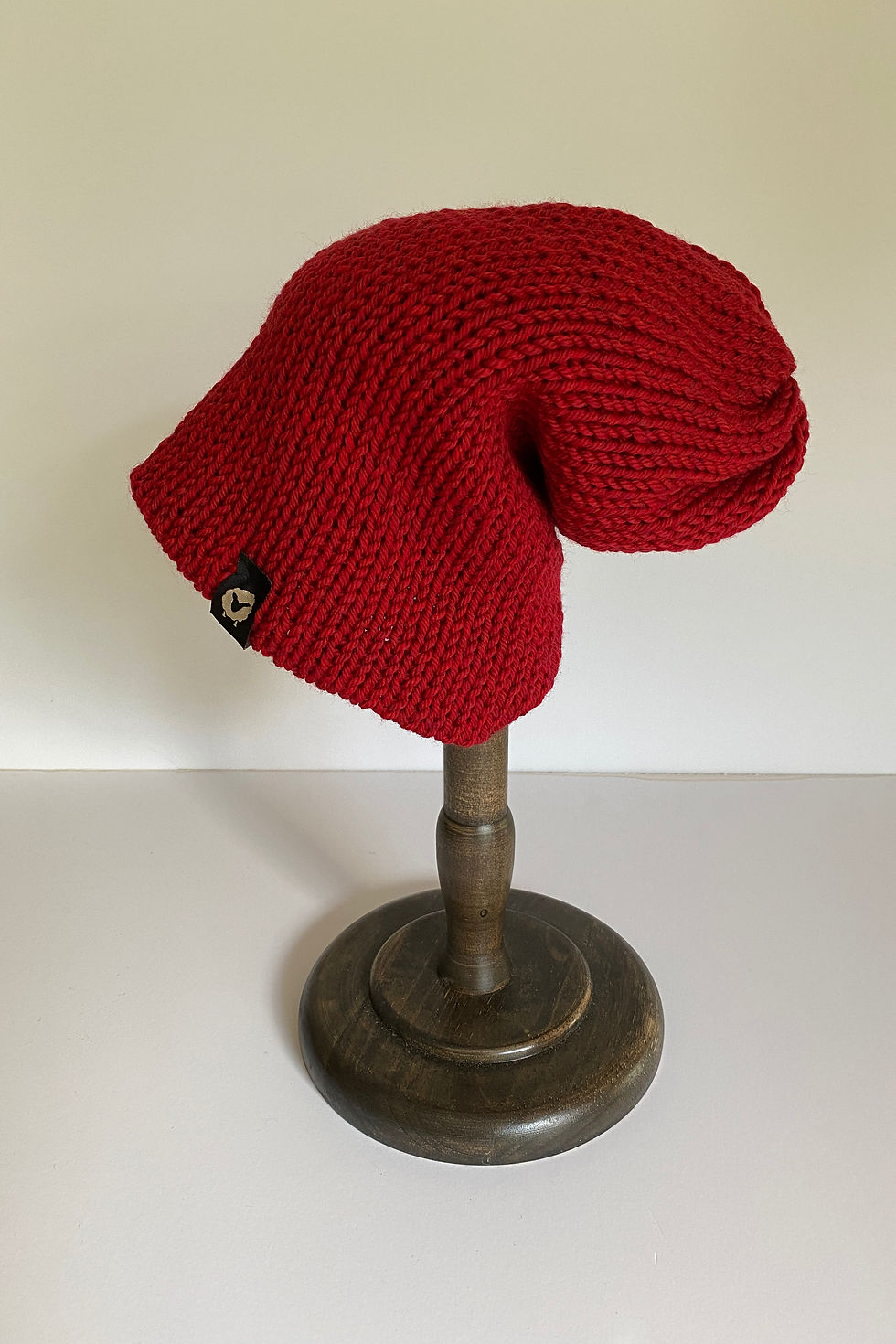 Thumbnail: Merino Beanie in heather Christmas red shown from an alternate angle.