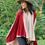 Thumbnail: Model wearing the Luxury Merino Wool Cardigan Wrap in oatmeal and carmine mid-weight rib merino wool, full-body pose.