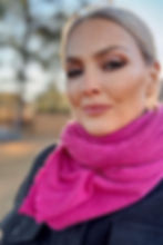 Model wearing the Merino Travel Wrap and Scarf in magenta marl mid-weight rib merino wool, full-body lifestyle pose.