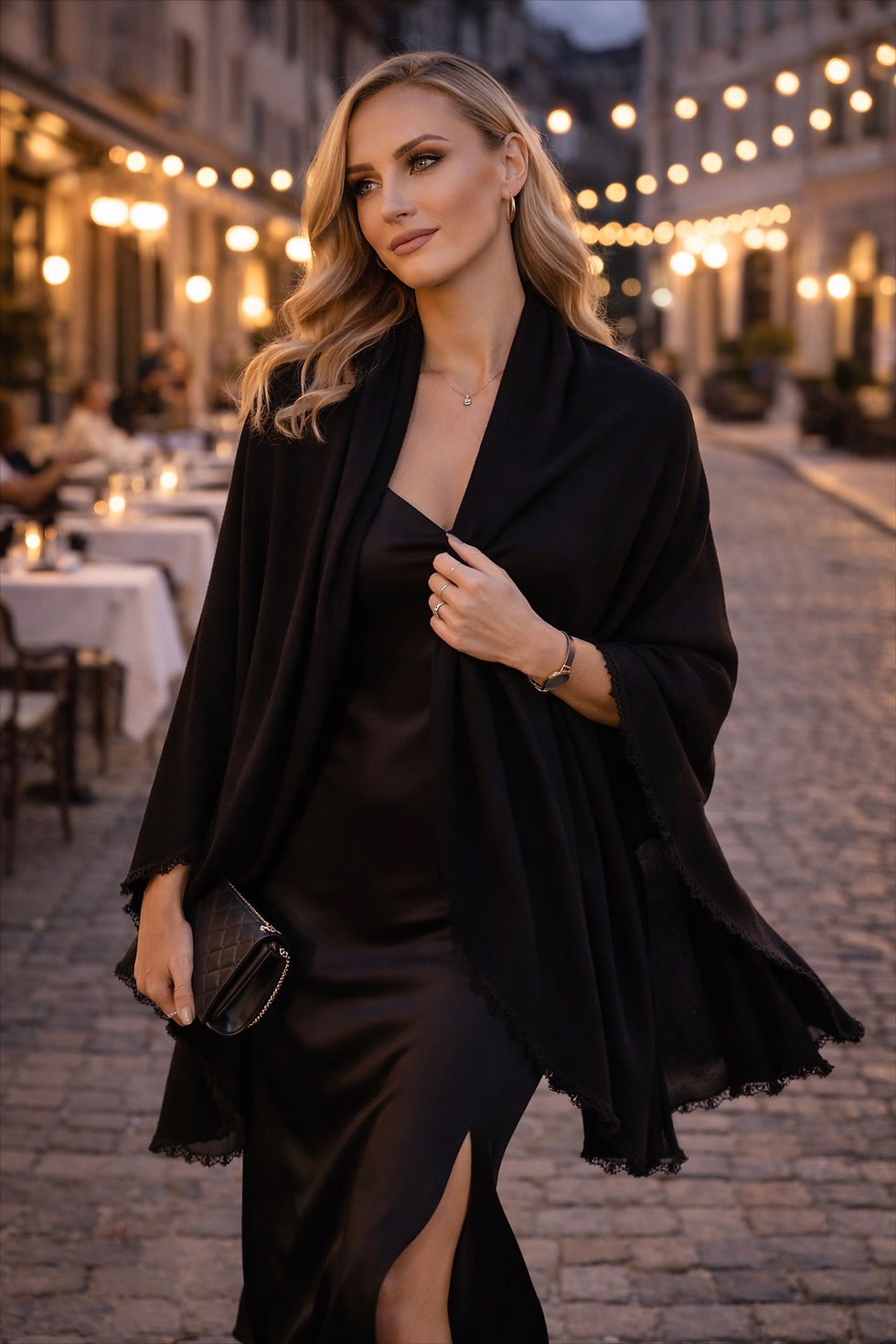 Model wearing the Merino Travel Wrap and Scarf in black mid-weight rib merino wool, dressed up for an event.