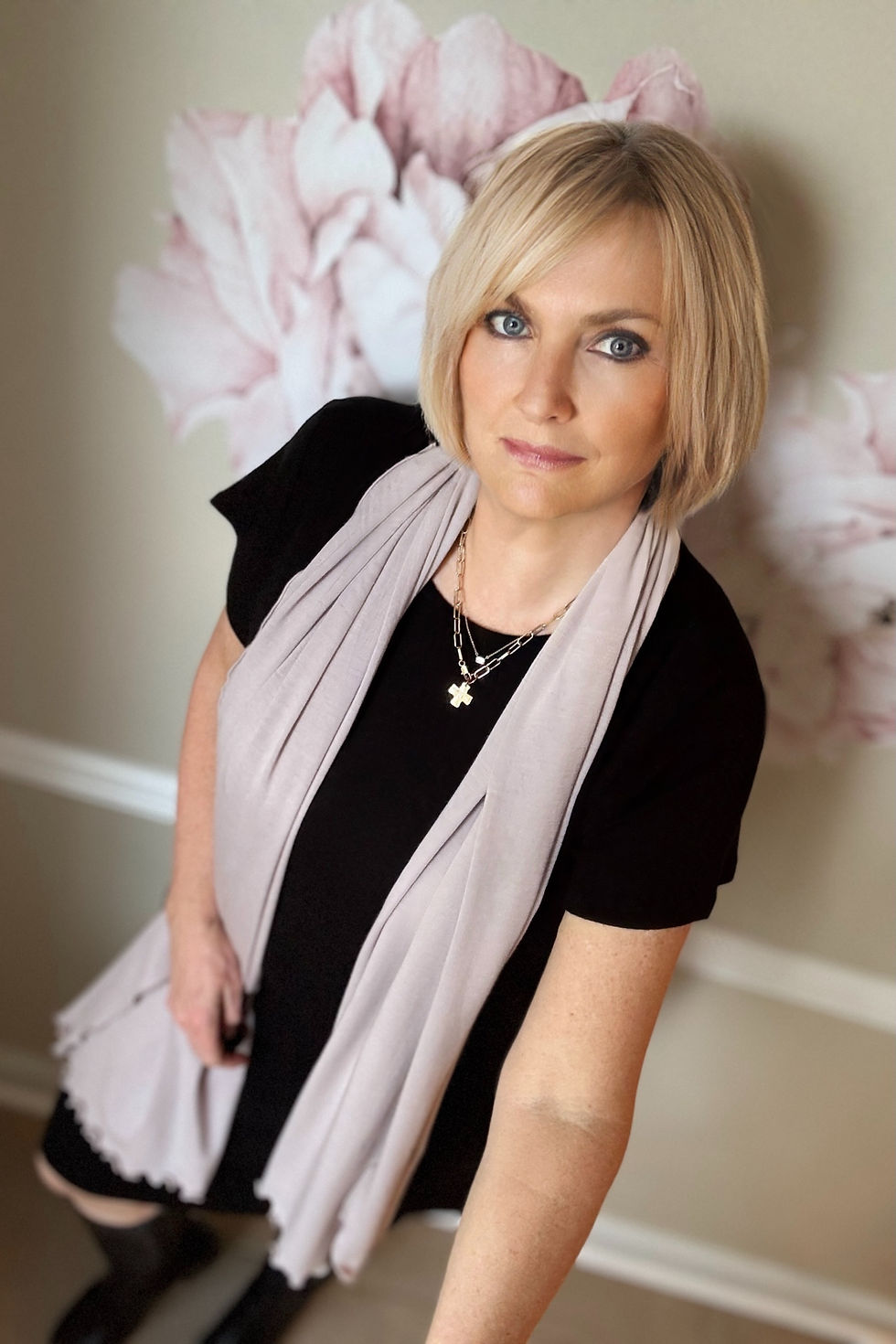 Model wearing merino Simone dress in black with oatmeal merino wrap around her neck.