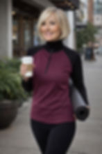 Model wearing the black mulberry Riley zip-neck merino top in a relaxed lifestyle pose.