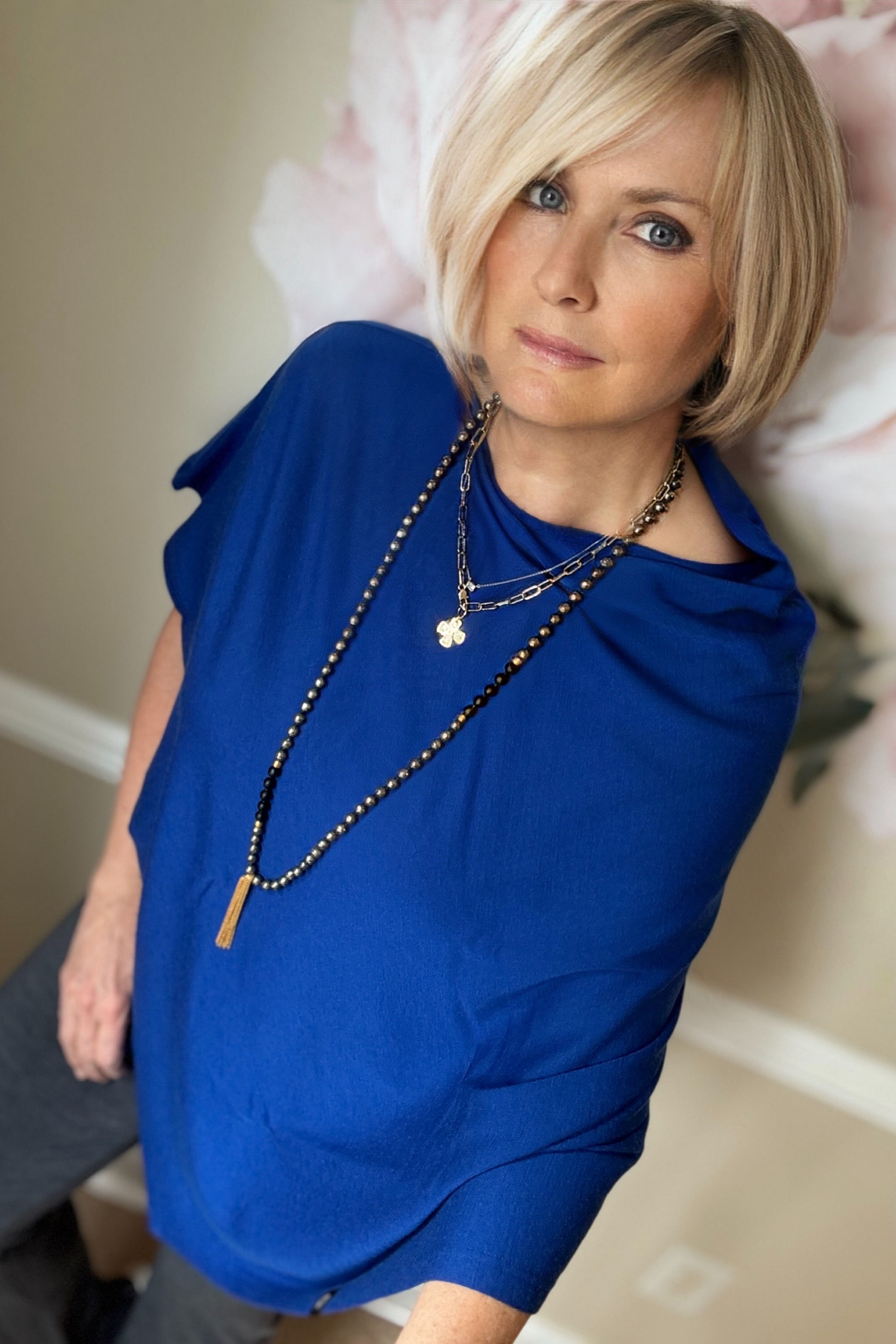 Close-up of the Merino Wool Poncho in blue showing mid-weight rib merino fabric and drape details.