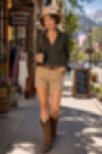 Woman wearing the olive striped Hayden zip-neck merino top in a relaxed outdoor pose.