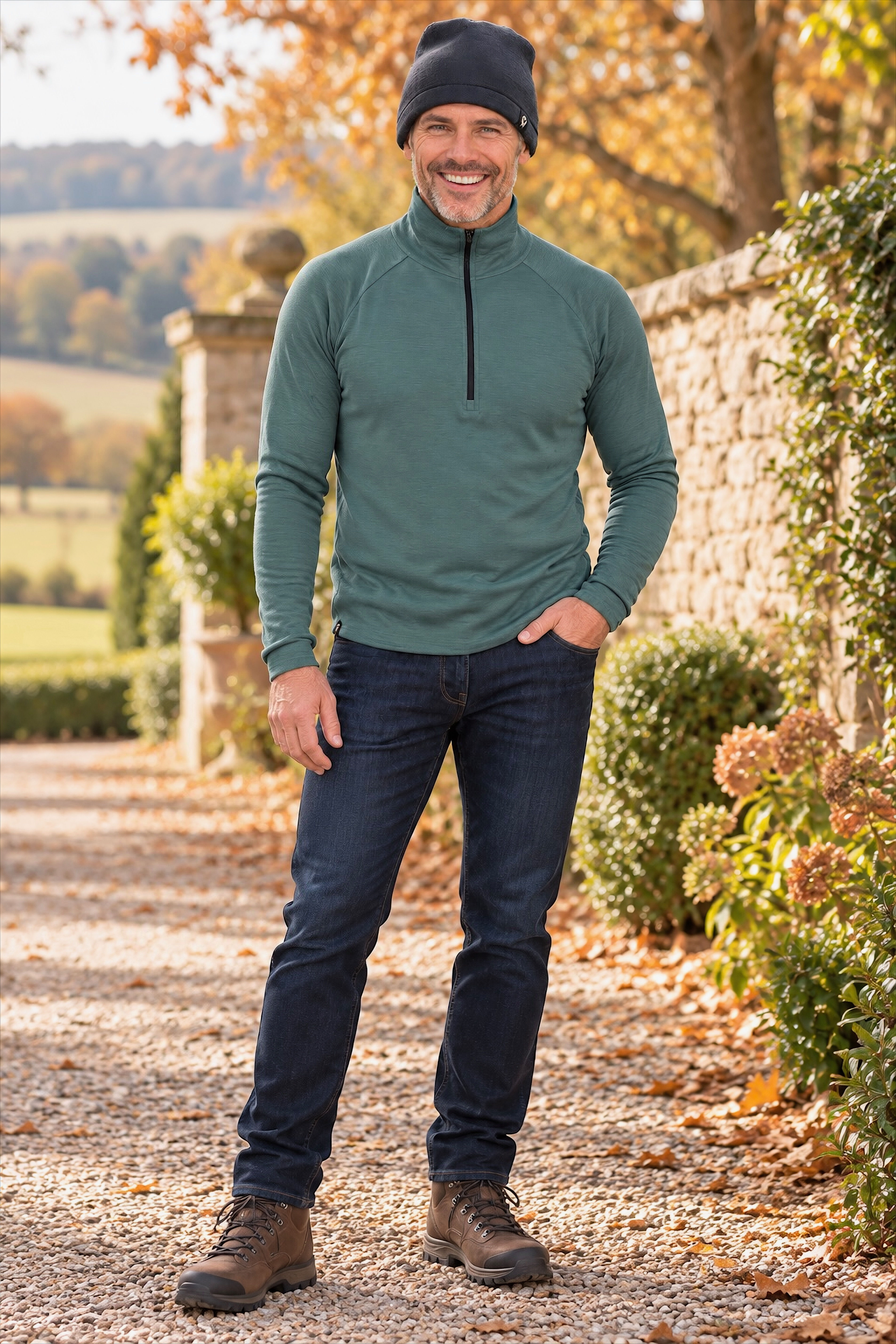 Male model wearing the Hayden men’s zip-neck top in sage lightweight rib merino wool, full-body lifestyle pose.