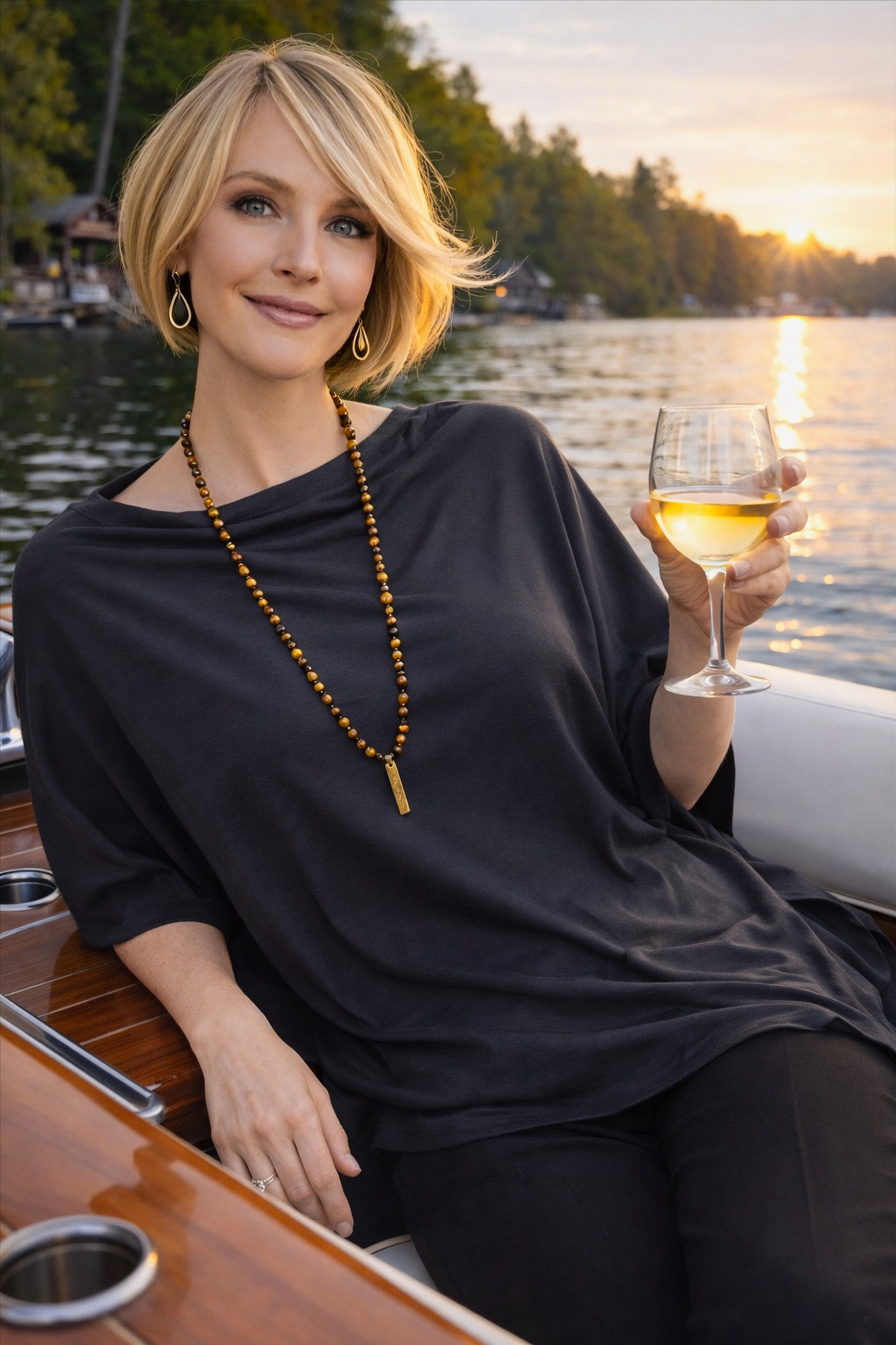 Woman wearing the dark grey Merino Wool Poncho in a relaxed lifestyle pose.