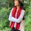 Thumbnail: Woman wearing the oatmeal and carmine Luxury Merino Wool Cardigan Wrap in a relaxed lifestyle pose, showing drape and fit.