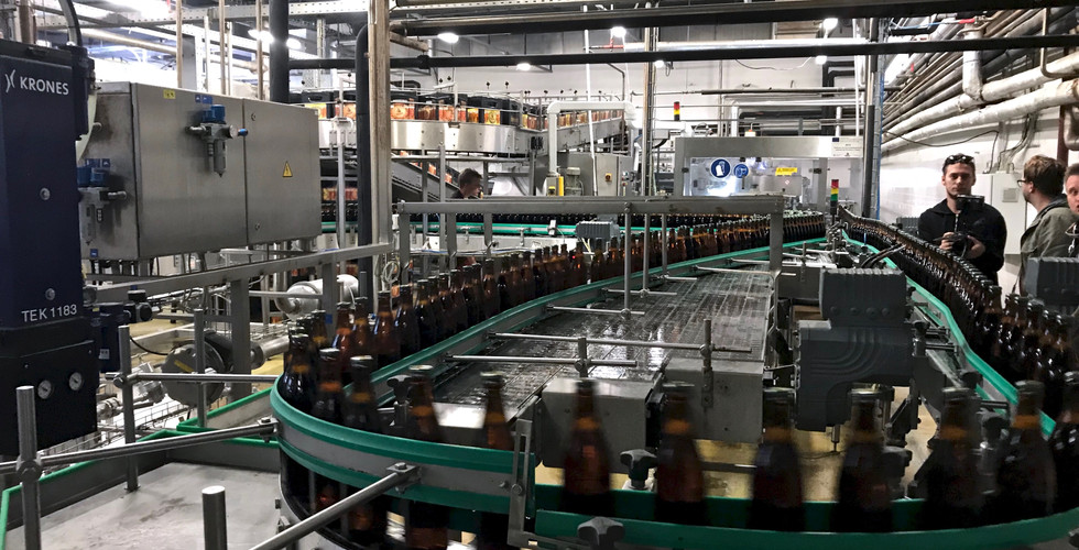 Bottles moving on brewery conveyor belt