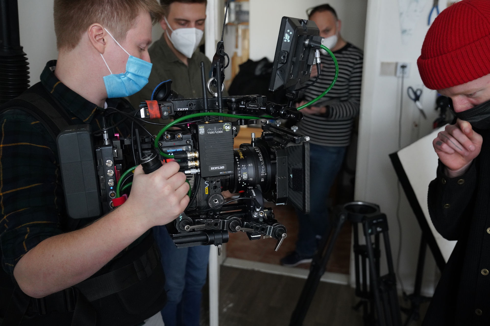 Film crew setting up camera equipment for shoot