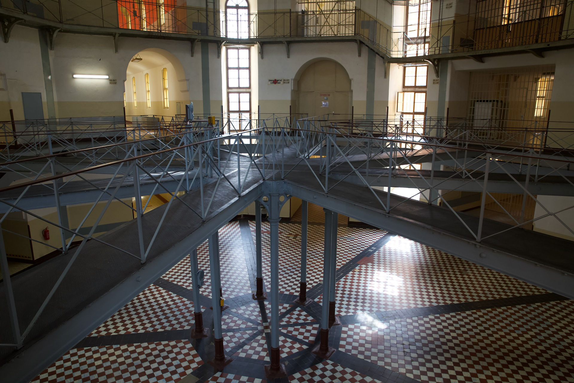 Panopticon prison interior:  metal walkways, tiled floor