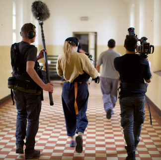 Film crew shooting scene in hallway