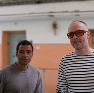 Two men posing in a hallway, Raphael Rowe