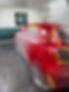 Red car in body shop, paint protection film