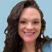 Smiling woman with brown curly hair