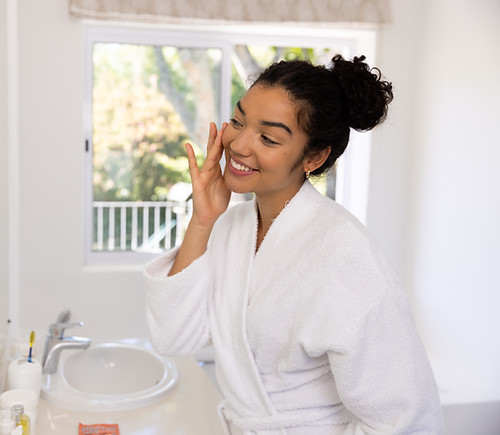 happy-biracial-woman-in-bathrobe-looking-in-mirror-2025-04-05-02-16-46-utc.jpg