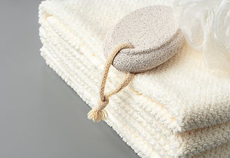 pumice-stone-and-stacked-towels-in-a-bathroom-2025-02-24-18-13-21-utc.jpg